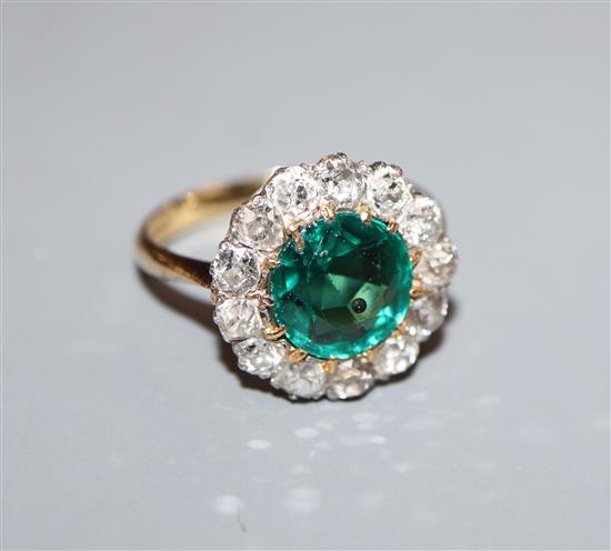 An 18ct, green garnet topped doublet and diamond cluster ring, size L.